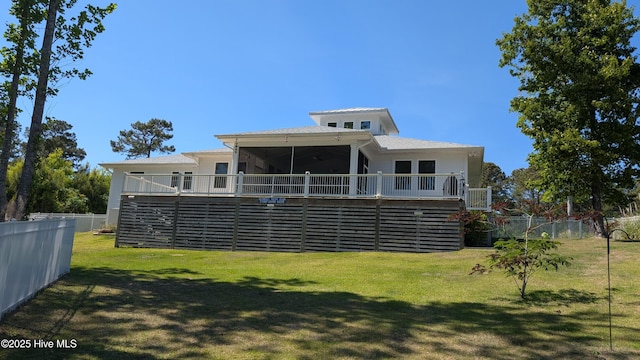 rear view of property with a wooden deck, a sunroom, and stairway