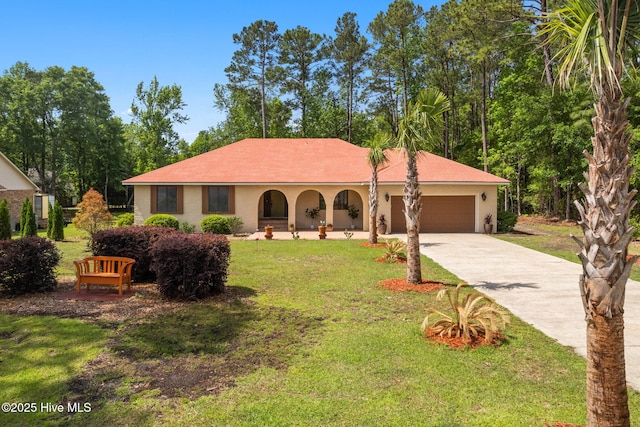 45 Fairway Dr, Shallotte, NC 28470 - view of front facade with a front yard, an attached garage, and concrete driveway