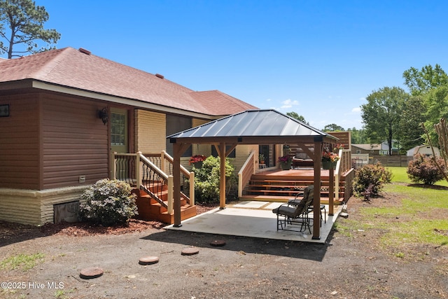 45 Fairway Dr, Shallotte, NC 28470 - back of property featuring a patio area, a shingled roof, a gazebo, and a wooden deck