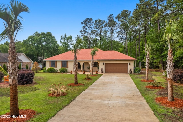 45 Fairway Dr, Shallotte, NC 28470 - view of front of home with concrete driveway, a garage, and a front yard