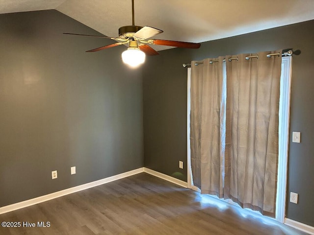 unfurnished room with ceiling fan, wood finished floors, vaulted ceiling, and baseboards