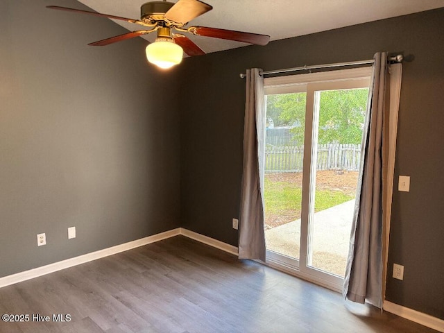 spare room with a ceiling fan, wood finished floors, and baseboards