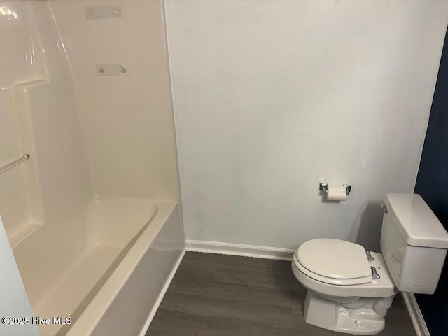 bathroom with baseboards, toilet, and wood finished floors