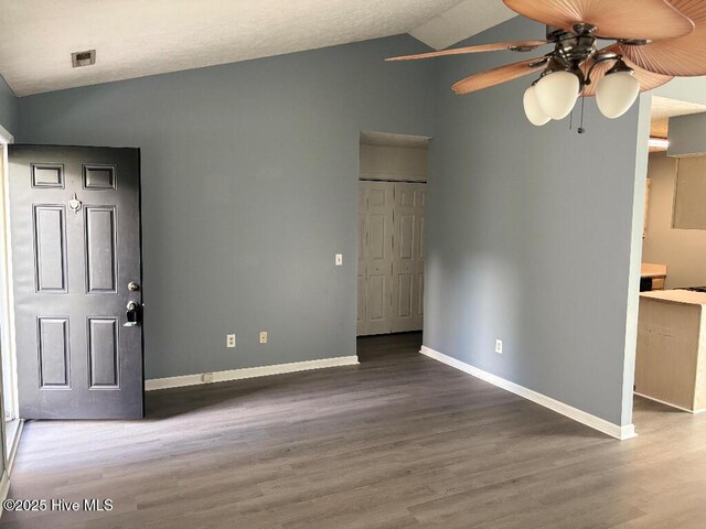 unfurnished bedroom featuring vaulted ceiling, wood finished floors, and baseboards