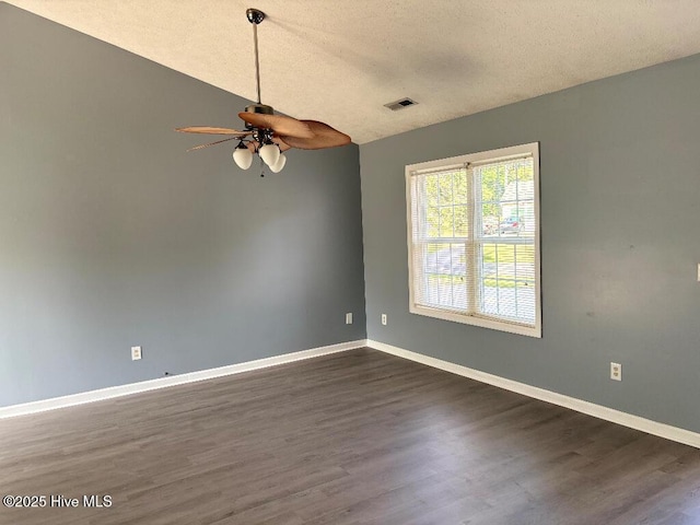 unfurnished room with a ceiling fan, dark wood finished floors, baseboards, and a textured ceiling