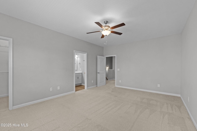 254 Great Egret Way, Beaufort, NC 28516 - unfurnished bedroom with a walk in closet, light colored carpet, and baseboards