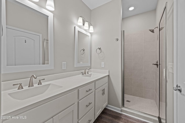 254 Great Egret Way, Beaufort, NC 28516 - bathroom featuring tiled shower, wood finished floors, double vanity, and baseboards