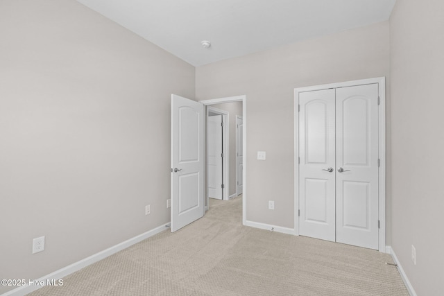254 Great Egret Way, Beaufort, NC 28516 - unfurnished bedroom featuring light colored carpet, baseboards, and a closet