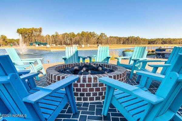 254 Great Egret Way, Beaufort, NC 28516 - view of patio with an outdoor fire pit, a water view, and a forest view