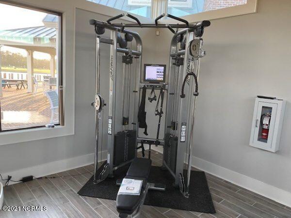 254 Great Egret Way, Beaufort, NC 28516 - exercise area with plenty of natural light, baseboards, and wood finish floors