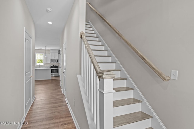 254 Great Egret Way, Beaufort, NC 28516 - stairway featuring wood finished floors, recessed lighting, and baseboards