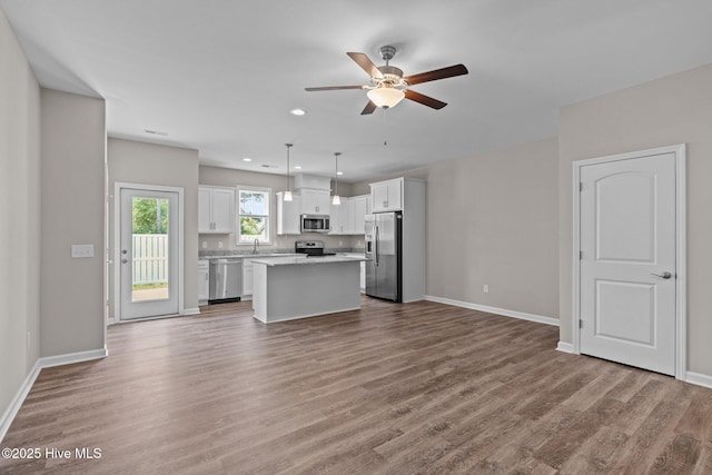 254 Great Egret Way, Beaufort, NC 28516 - unfurnished living room featuring a ceiling fan, wood finished floors, baseboards, a sink, and recessed lighting