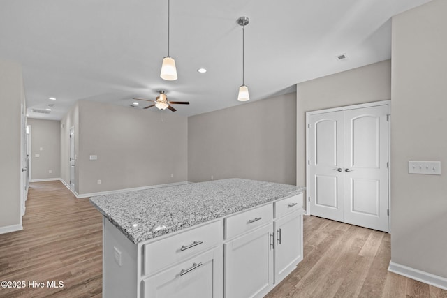254 Great Egret Way, Beaufort, NC 28516 - kitchen featuring light wood-style flooring, ceiling fan, decorative light fixtures, white cabinets, and baseboards
