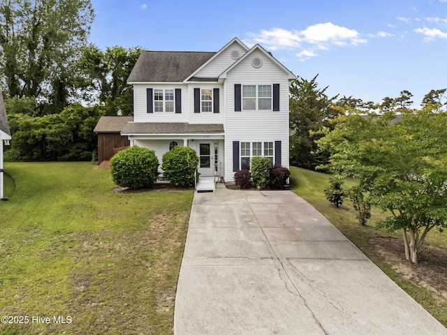 4979 Montserrat Dr, Southport, NC 28461 - traditional-style home featuring a front yard, a shingled roof, and concrete driveway