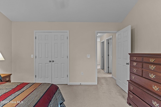 4979 Montserrat Dr, Southport, NC 28461 - bedroom featuring light colored carpet, a closet, and baseboards
