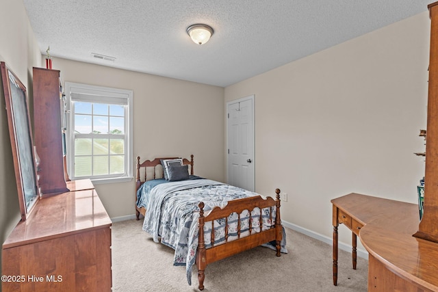 4979 Montserrat Dr, Southport, NC 28461 - bedroom with light carpet, baseboards, and a textured ceiling