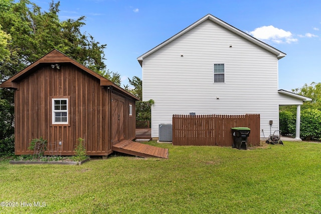 4979 Montserrat Dr, Southport, NC 28461 - view of property exterior featuring central AC unit, an outbuilding, and a lawn