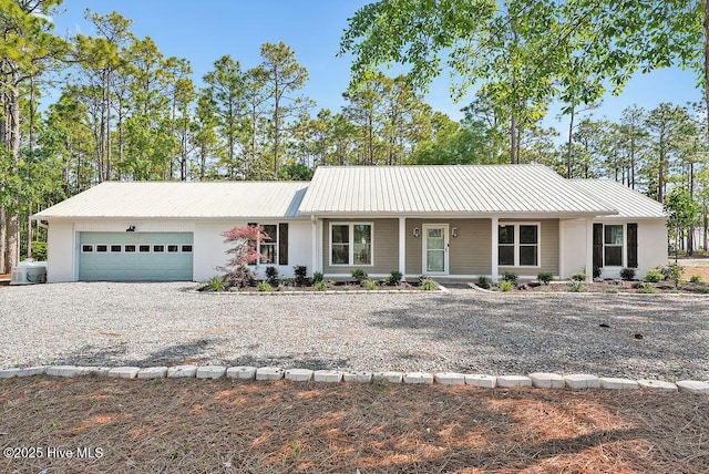 1324 S Shore Dr, Southport, NC 28461 - ranch-style home with an attached garage, driveway, metal roof, and a porch
