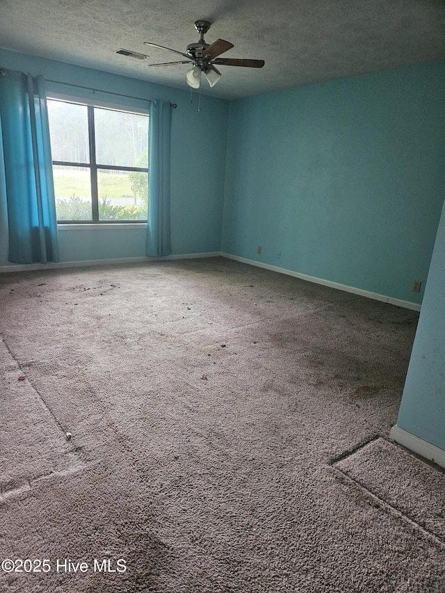 4 Cleek Ct, Carolina Shores, NC 28467 - empty room with a textured ceiling, ceiling fan, carpet, and baseboards