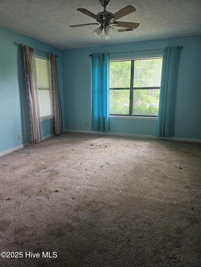4 Cleek Ct, Carolina Shores, NC 28467 - carpeted spare room featuring ceiling fan, a textured ceiling, and baseboards