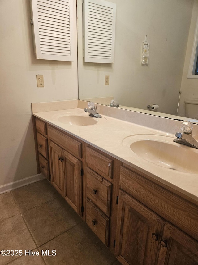 4 Cleek Ct, Carolina Shores, NC 28467 - full bath featuring double vanity, toilet, tile patterned floors, and baseboards