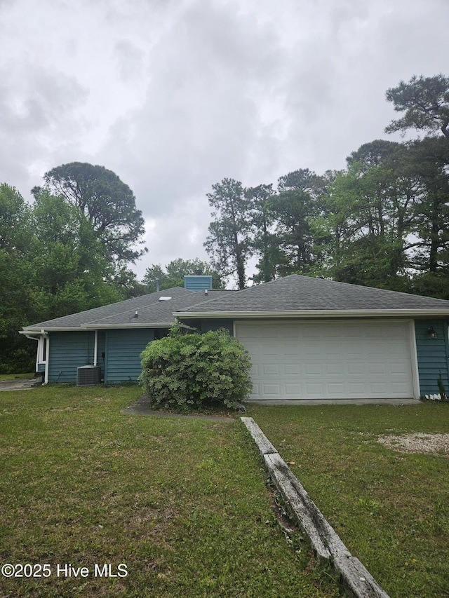 4 Cleek Ct, Carolina Shores, NC 28467 - rear view of house with a garage, central air condition unit, and a yard
