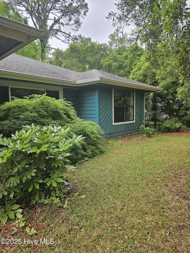 4 Cleek Ct, Carolina Shores, NC 28467 - view of side of home with a lawn and roof with shingles