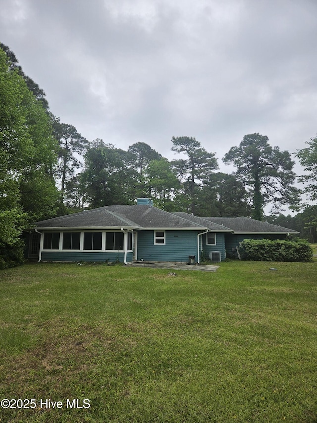 4 Cleek Ct, Carolina Shores, NC 28467 - view of front of property featuring a front yard, a patio, a sunroom, and cooling unit
