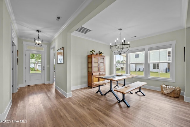 357 Spicer Lake Dr, Holly Ridge, NC 28445 - entrance foyer with a chandelier, ornamental molding, light wood-type flooring, and baseboards