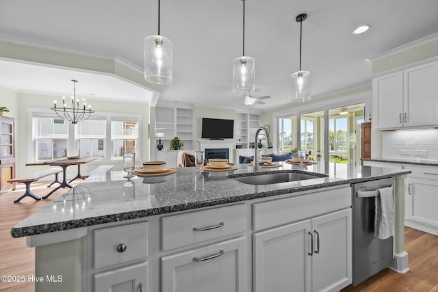 357 Spicer Lake Dr, Holly Ridge, NC 28445 - kitchen featuring a sink, ceiling fan, dishwasher, wood finished floors, and a fireplace
