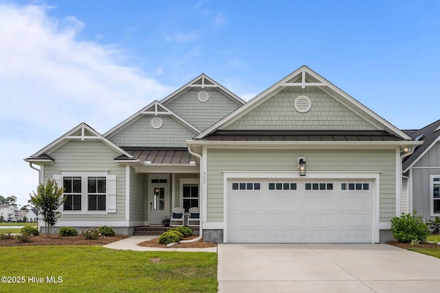 357 Spicer Lake Dr, Holly Ridge, NC 28445 - craftsman-style home featuring a standing seam roof, concrete driveway, a garage, a front lawn, and metal roof