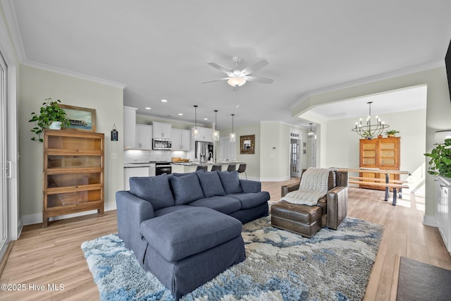 357 Spicer Lake Dr, Holly Ridge, NC 28445 - living room featuring a chandelier, a ceiling fan, light wood-style floors, crown molding, and baseboards