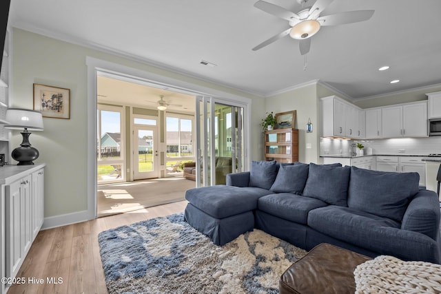 357 Spicer Lake Dr, Holly Ridge, NC 28445 - living room featuring a ceiling fan, crown molding, light wood-type flooring, baseboards, and recessed lighting