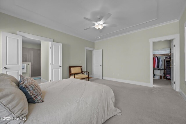 357 Spicer Lake Dr, Holly Ridge, NC 28445 - bedroom with attic access, light colored carpet, baseboards, a walk in closet, and crown molding