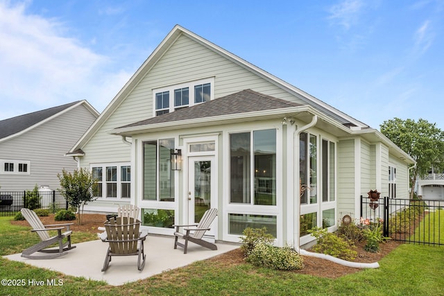 357 Spicer Lake Dr, Holly Ridge, NC 28445 - back of property with a sunroom, a patio area, and roof with shingles