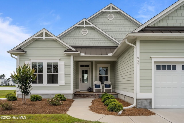357 Spicer Lake Dr, Holly Ridge, NC 28445 - view of front of house featuring a porch, a standing seam roof, a garage, and metal roof