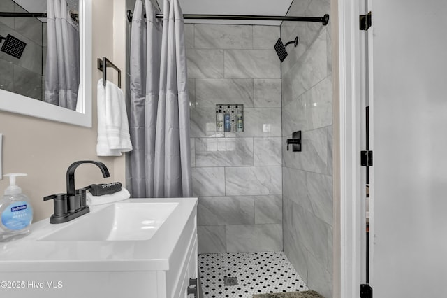 full bath with a stall shower and vanity