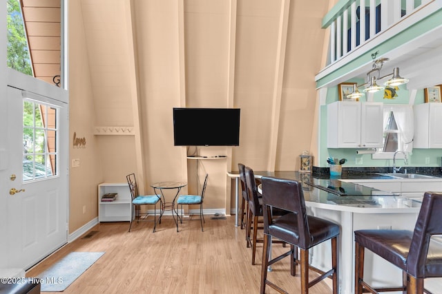 159 NE 31st St, Oak Island, NC 28465 - dining area with light wood-style floors and baseboards