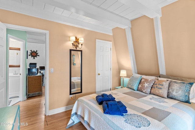 159 NE 31st St, Oak Island, NC 28465 - bedroom with beamed ceiling, light wood finished floors, baseboards, and wooden ceiling