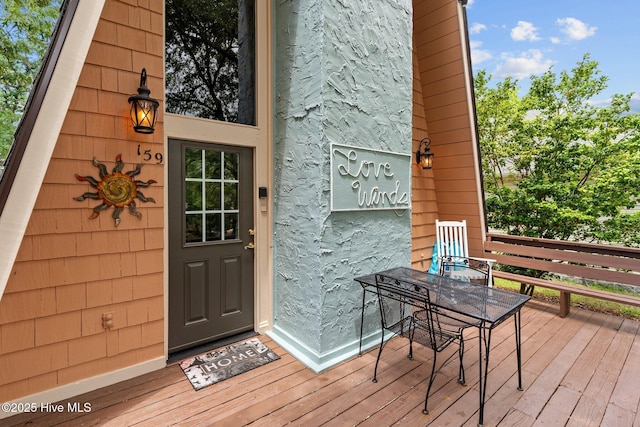 159 NE 31st St, Oak Island, NC 28465 - property entrance featuring a deck and outdoor dining area