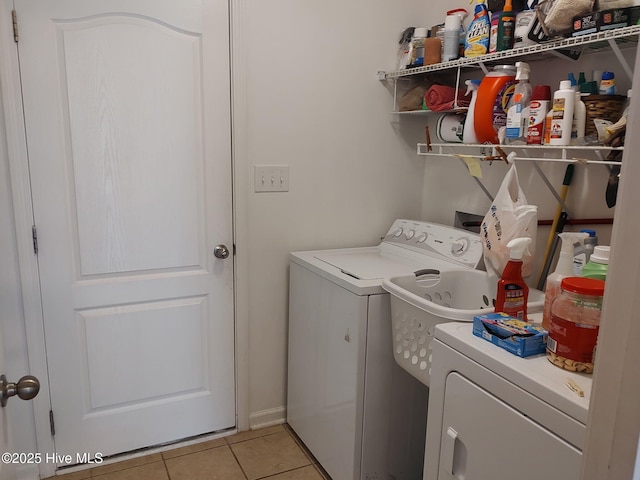 laundry area featuring washing machine and dryer and light tile patterned floors