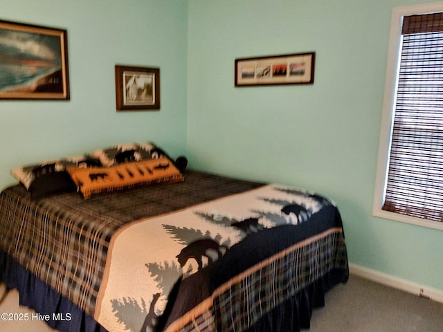 carpeted bedroom featuring baseboards