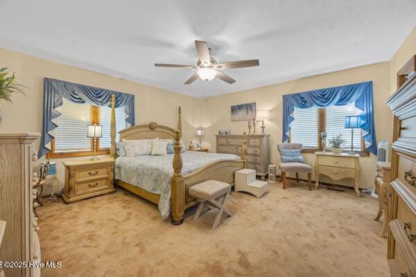 bedroom with light carpet and ceiling fan