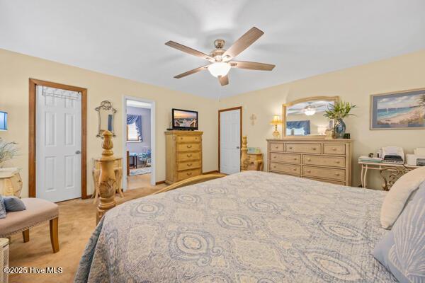 bedroom with light colored carpet and ceiling fan
