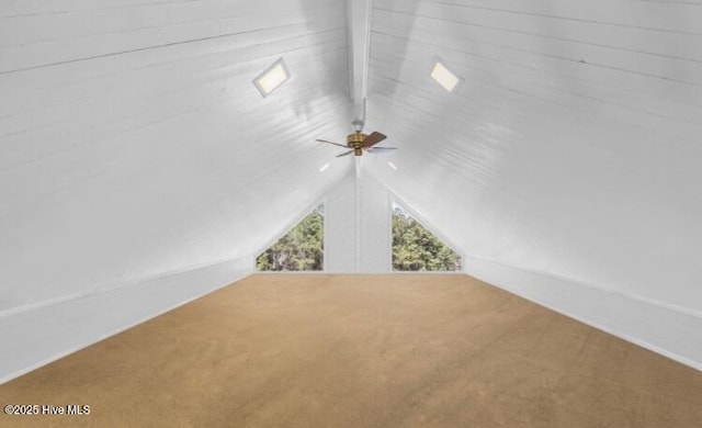 additional living space featuring vaulted ceiling, carpet, and a ceiling fan