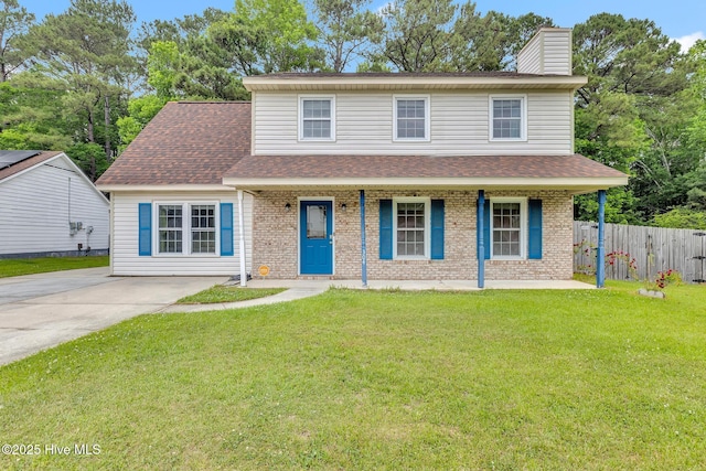 304 Pebble Ln, Jacksonville, NC 28546 - view of front of property with covered porch, brick siding, a chimney, and a shingled roof