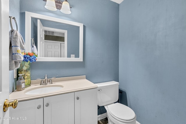 304 Pebble Ln, Jacksonville, NC 28546 - bathroom with toilet, vanity, and baseboards