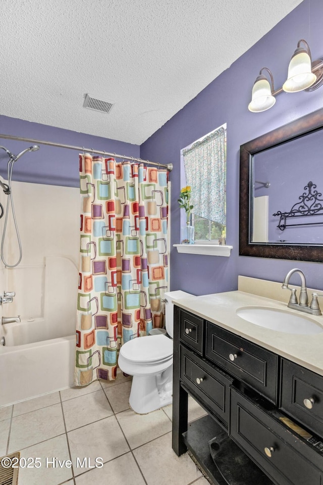 304 Pebble Ln, Jacksonville, NC 28546 - bathroom with tile patterned floors, vanity, toilet, a textured ceiling, and shower / tub combo with curtain