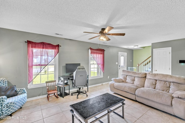 304 Pebble Ln, Jacksonville, NC 28546 - living area featuring healthy amount of natural light, a ceiling fan, light tile patterned flooring, a textured ceiling, and baseboards