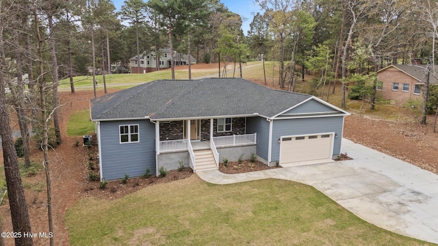 ranch-style house featuring a porch, concrete driveway, a garage, and a front yard